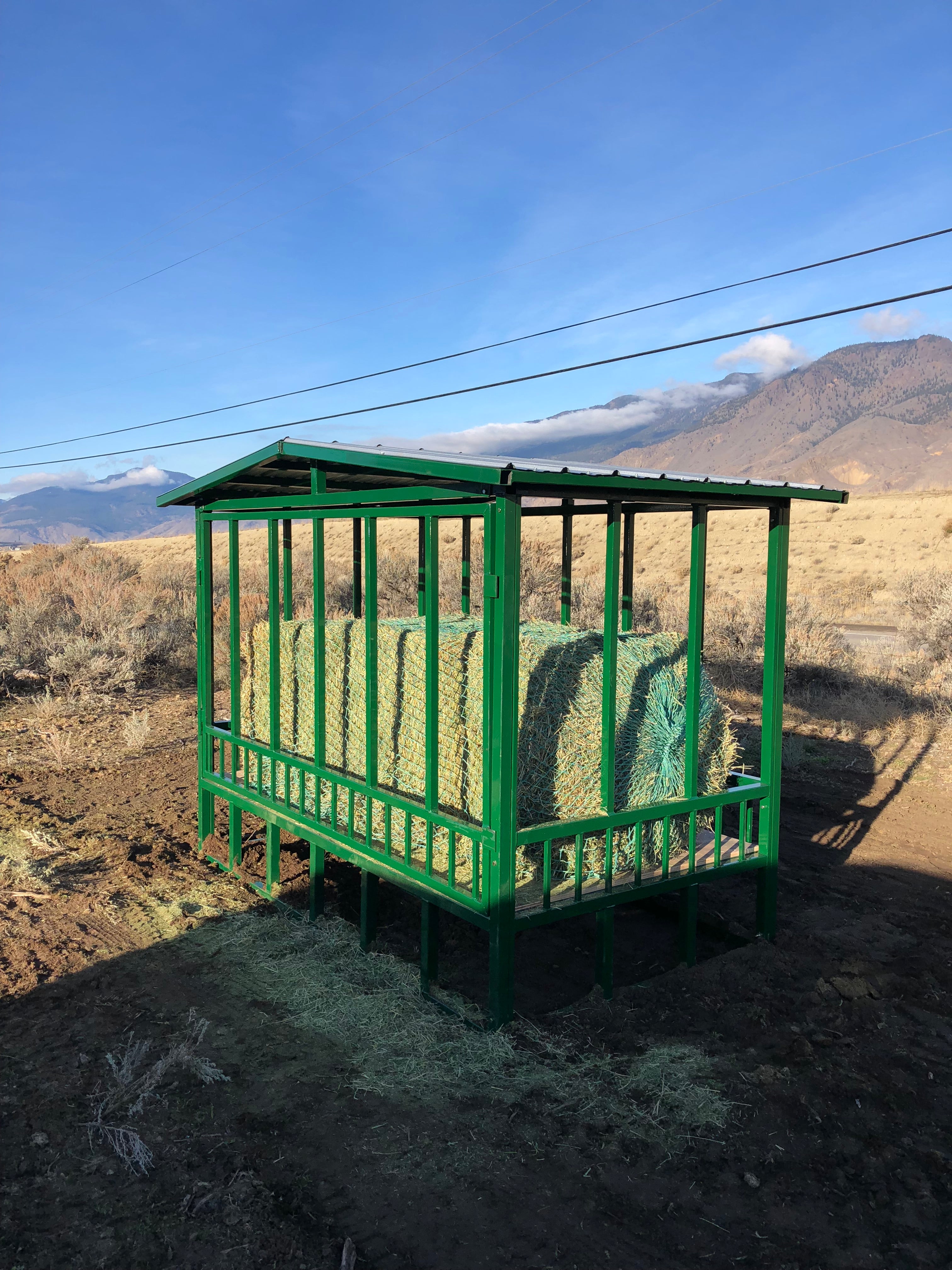 green hay net in a large square bale feeder