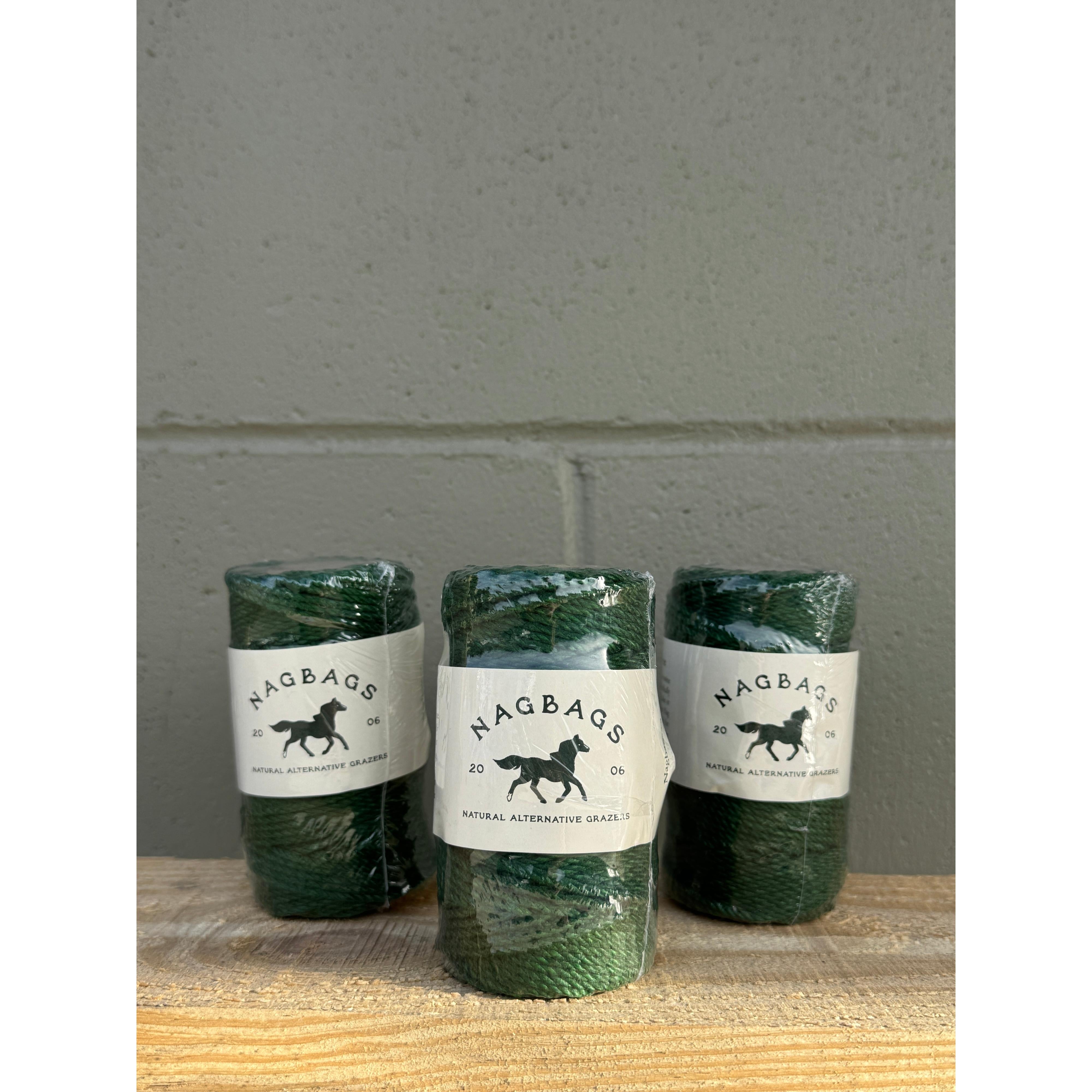 Three green bottles with labels on a gray surface