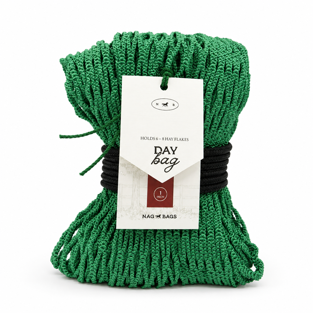 Green hay net wrapped up with braided black rope white paper hangtag reading 'DAY bag' and 'HOLDS - 8 HAY FLAKES', photographed on a clean white background.