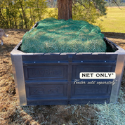 Hay feeder with green netting on a field background