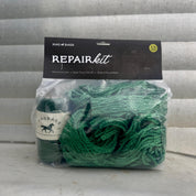 Green repair kit with packaging on a wooden surface