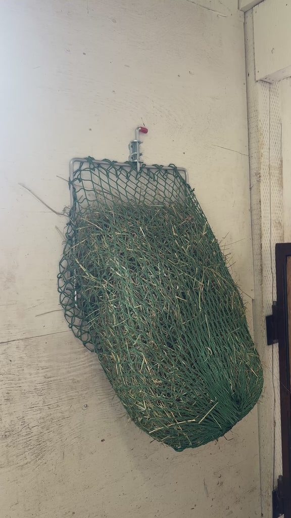 Flip-up hay net hanging on a wall 